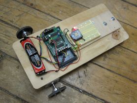 A bare-bones rolling robot on the floor