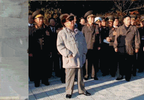 A rapid sequence of photographs of Kim Jong Il looking at things, centered on his face